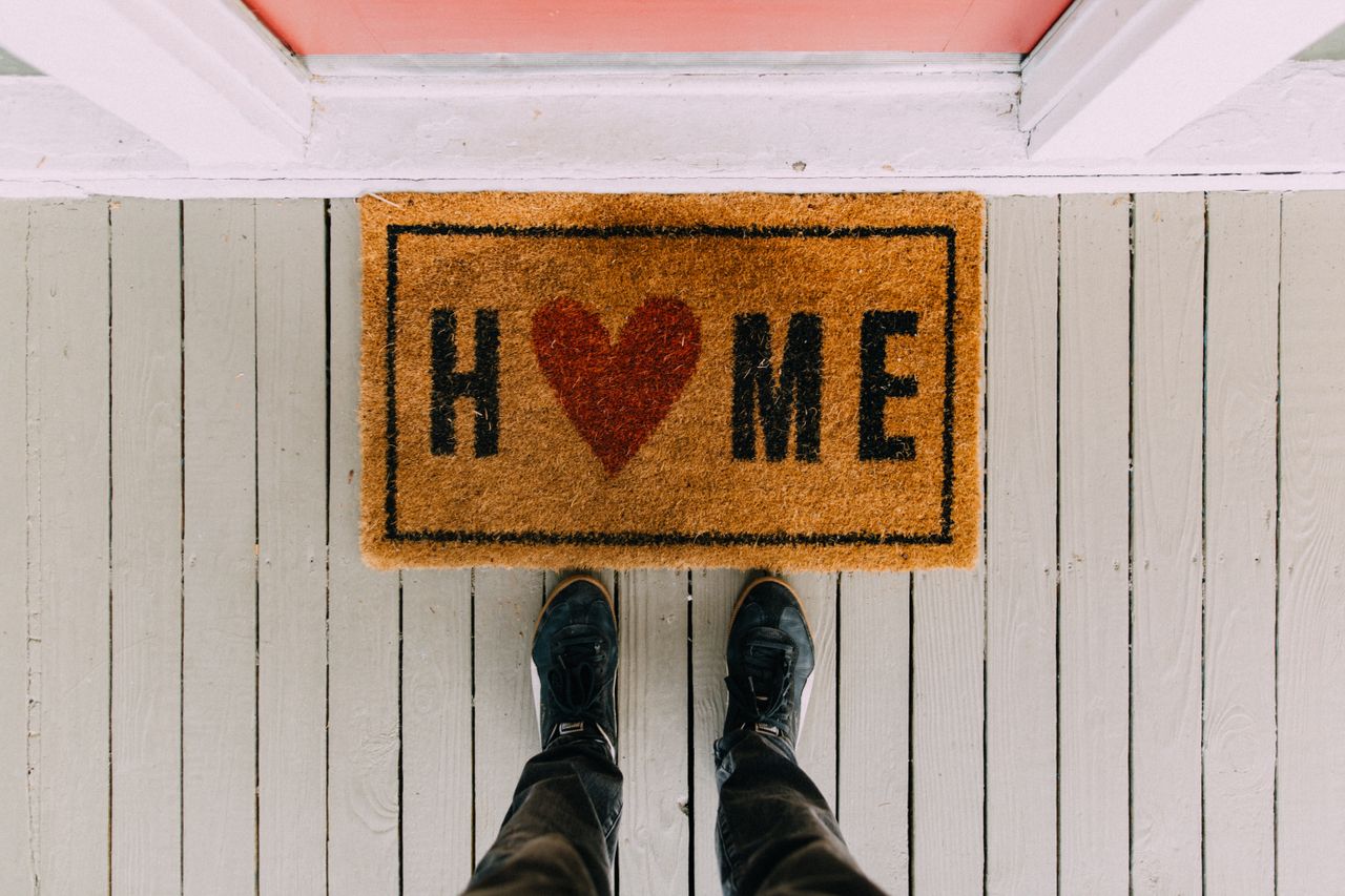hero-img-02 A creative doormat with heart motif symbolizing home at a front porch entrance.