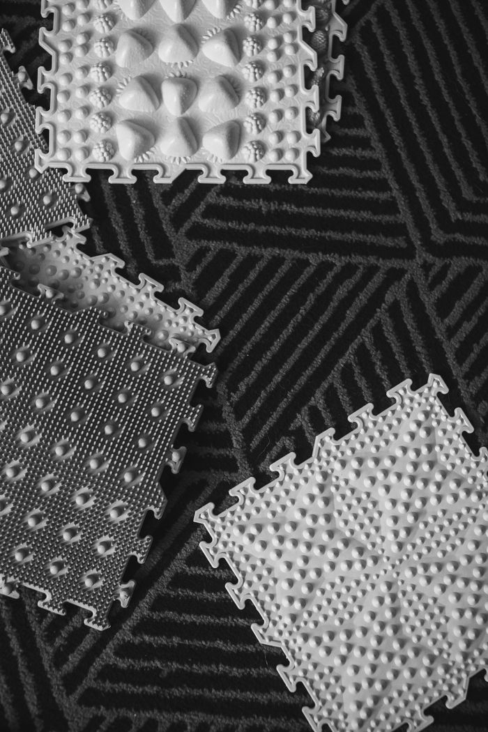 services-03 Black and white photo featuring geometric textured mats with a contrasting patterned background.